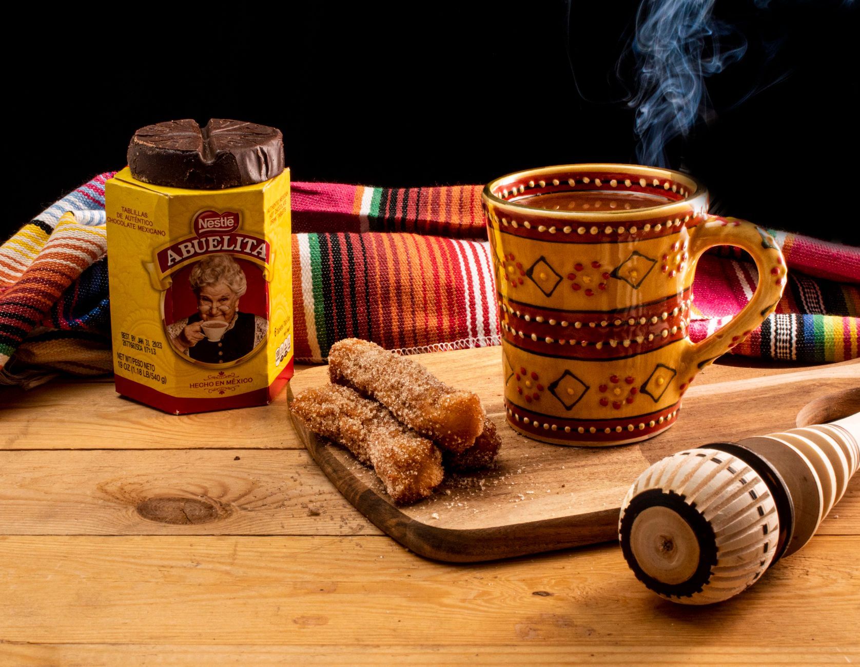 Churros con chocolate, fried dough with a cup of thick drinking chocolate