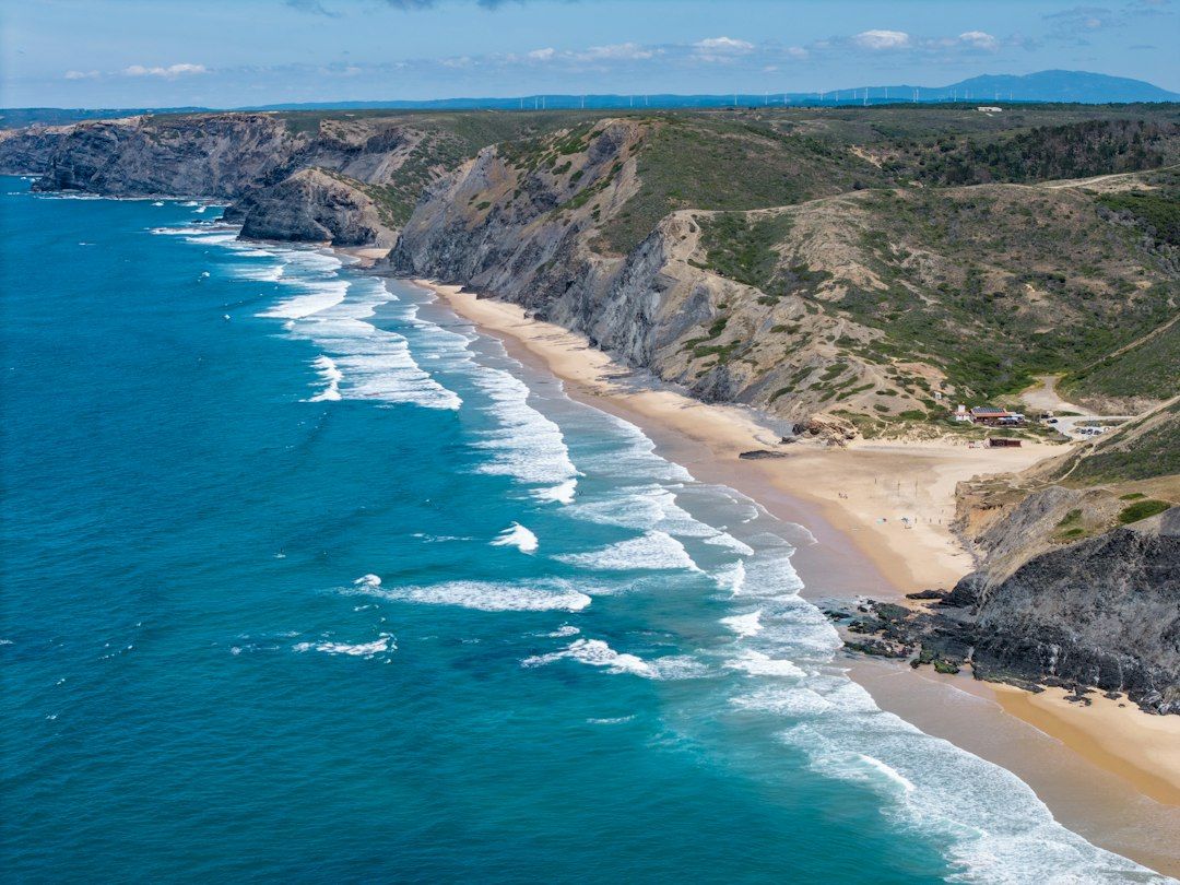 Praia do Castelejo beneath dark west-coast cliffs