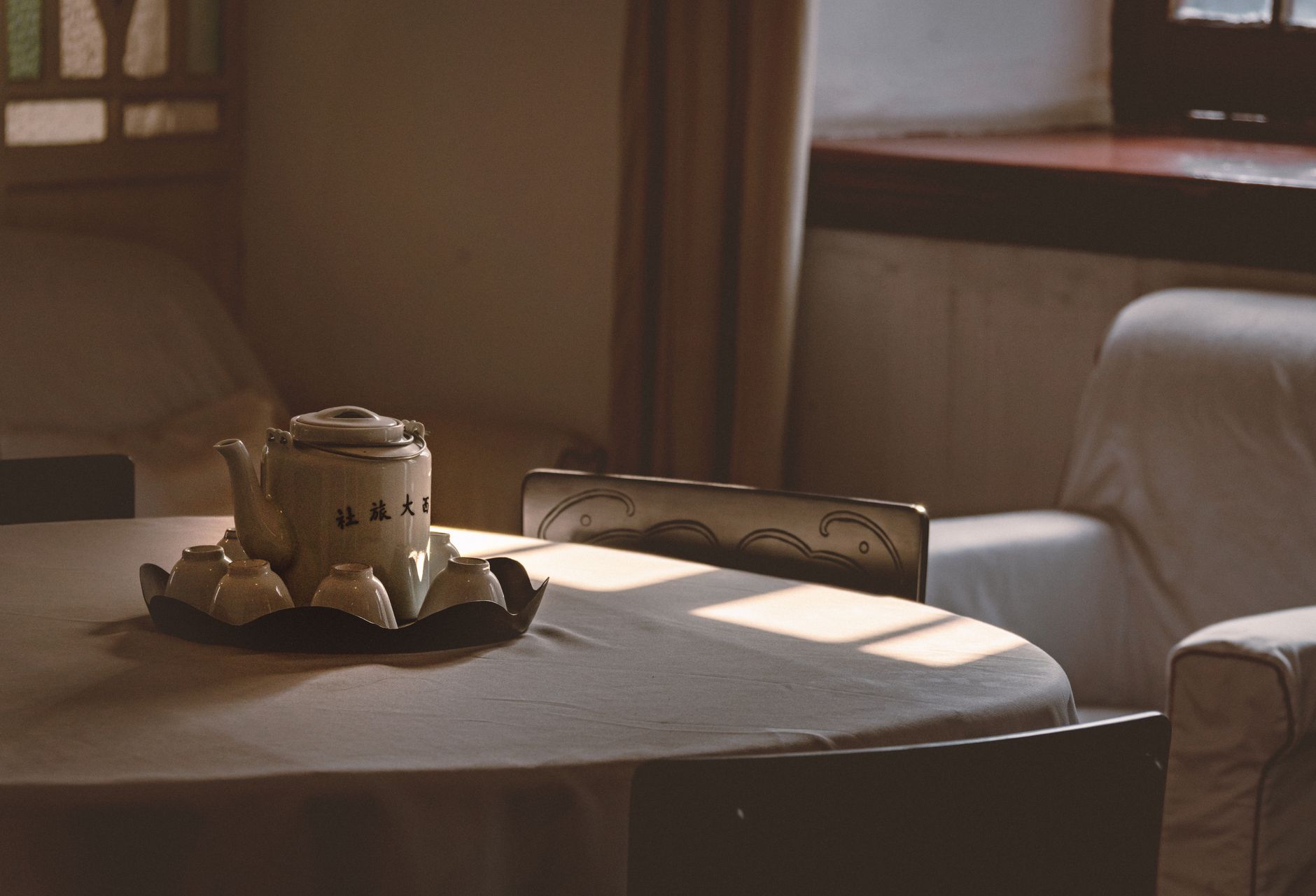 A quiet living room with natural light and a cup of tea on a table